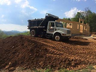 Using a large Dump Truck to Haul Dirt excavated from the Houser Job.